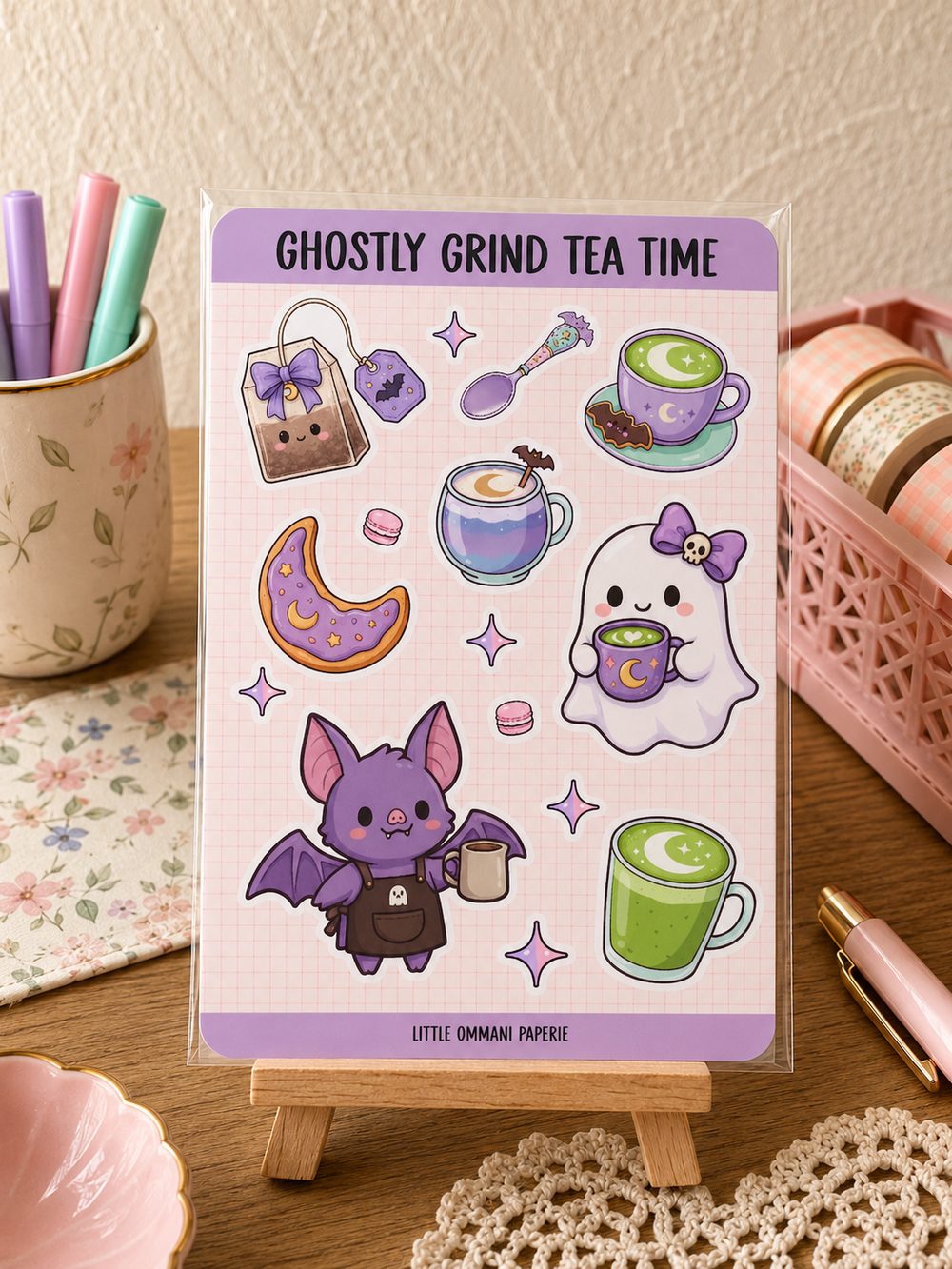 Ghostly Grind Tea Time sticker sheet displayed on a wooden desk