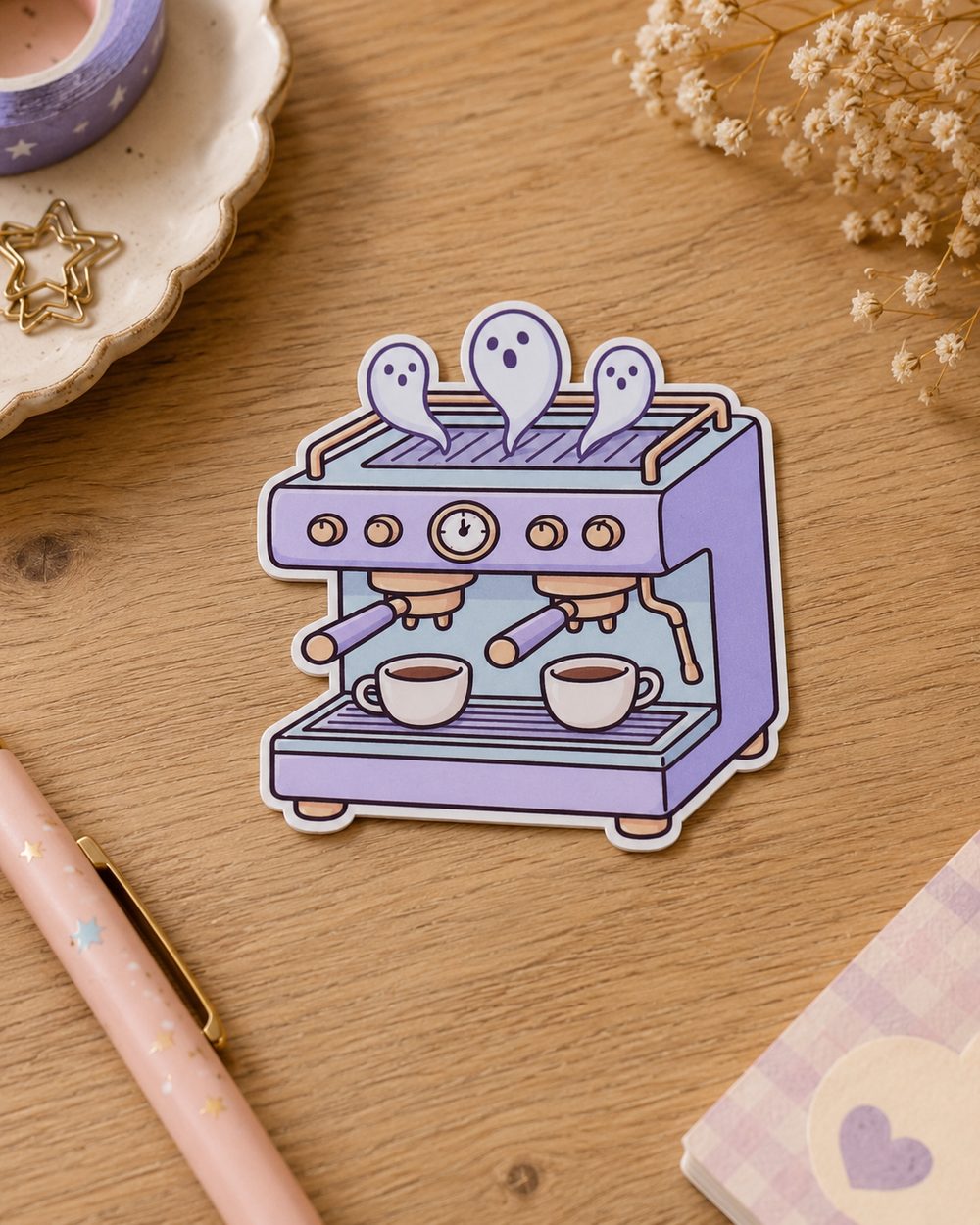 Ghostly Espresso Machine die-cut sticker displayed on a wooden desk
